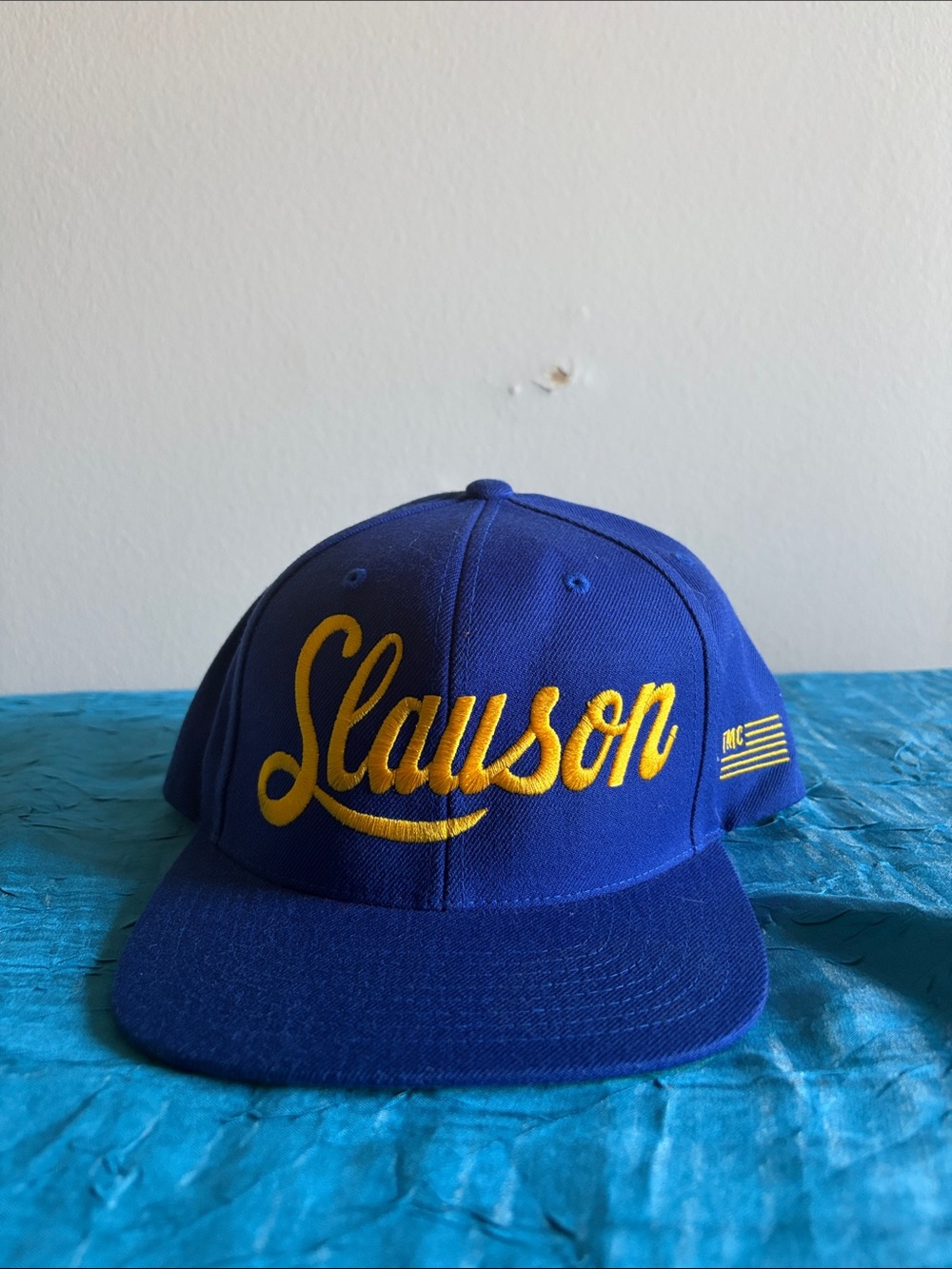 Slauson embroidered in yellow on a 6-panel royal blue adjustable snapback